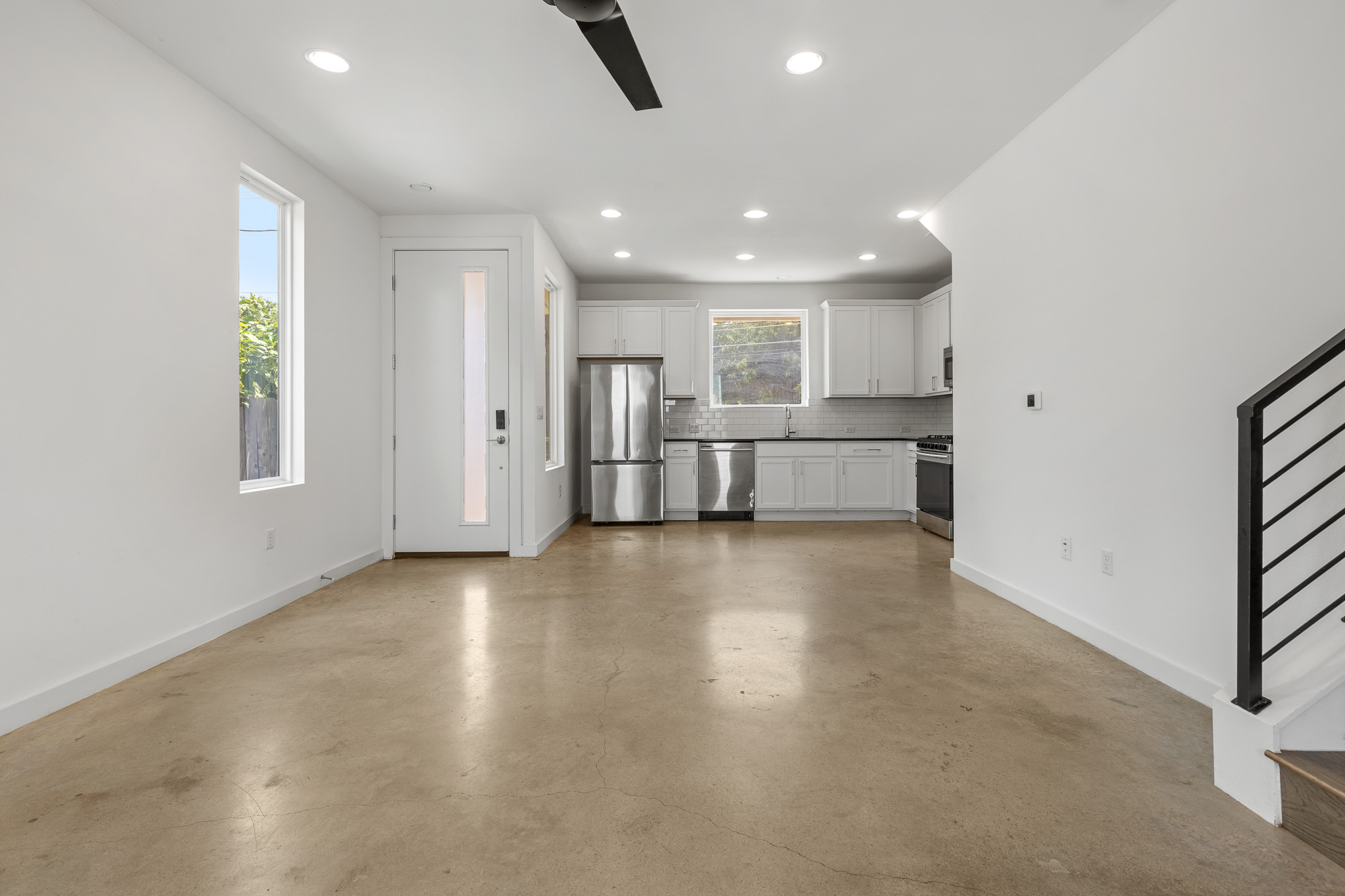 2604 Wheless Lane, Unit 1 Austin, TX 78723 - Photo 5 of 38 Sunlit living room with soaring white walls and abundant natural light from strategically placed windows.