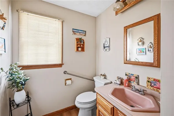 a bathroom with a toilet sink and mirror