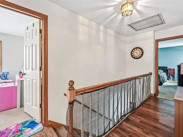 a view of a hallway to a bedroom and wooden floor