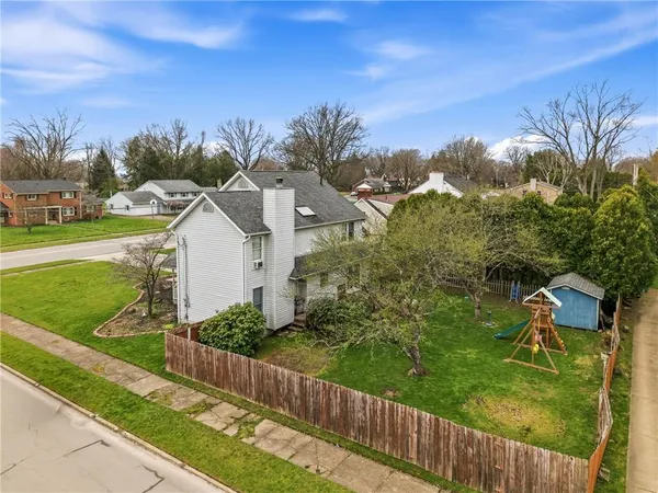 a view of a house with a yard and potted plants