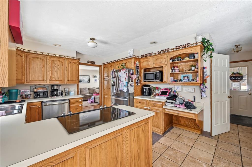 1359 Highland Road Sharon, PA 16146 - Photo 8 of 32 a kitchen with stainless steel appliances granite countertop a sink dishwasher stove top oven and cabinets with wooden floor