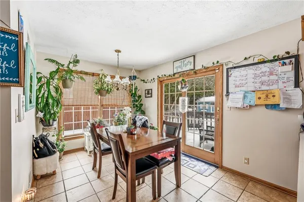 a view of a dining room with furniture and a potted plant