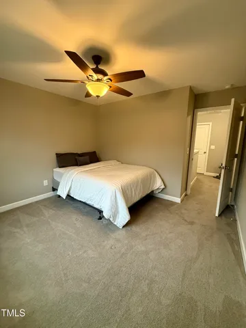 a bed sitting in a room next to a blue wall