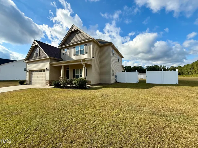 a front view of a house with a yard