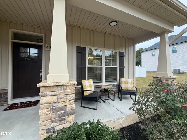 a building outdoor space with patio furniture and potted plants