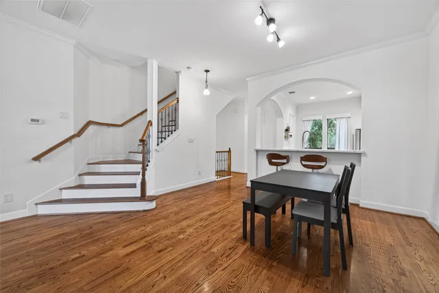 a view of a dining room with furniture and wooden floor