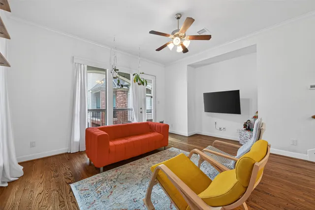 a living room with furniture and wooden floor
