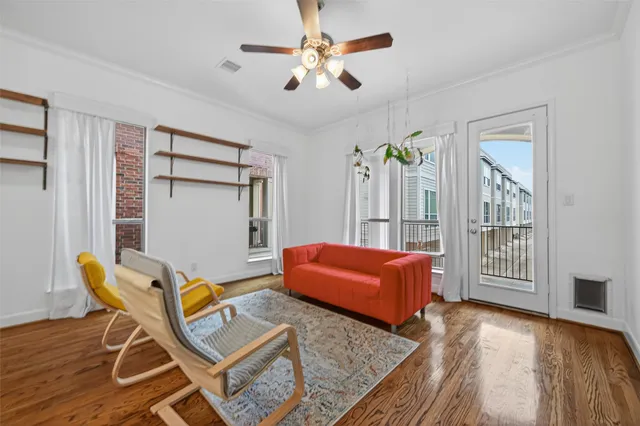 a living room with furniture and wooden floor