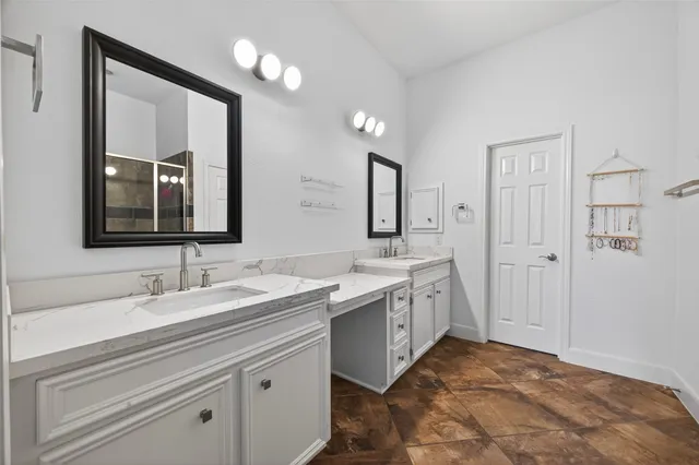 a spacious bathroom with a double vanity sink and a mirror