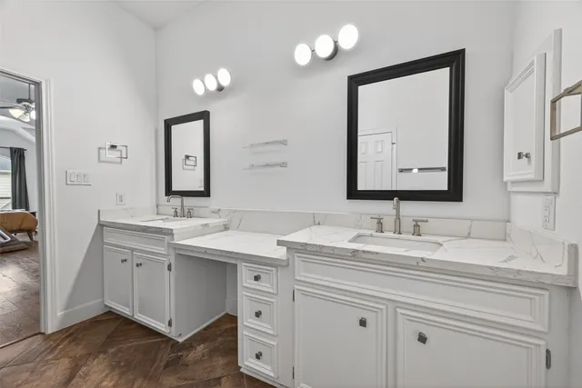 a bathroom with a double vanity sink and a mirror