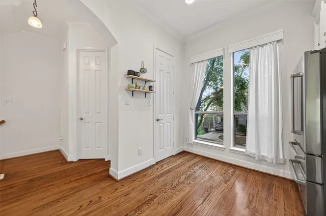 wooden floor in an empty room with a window