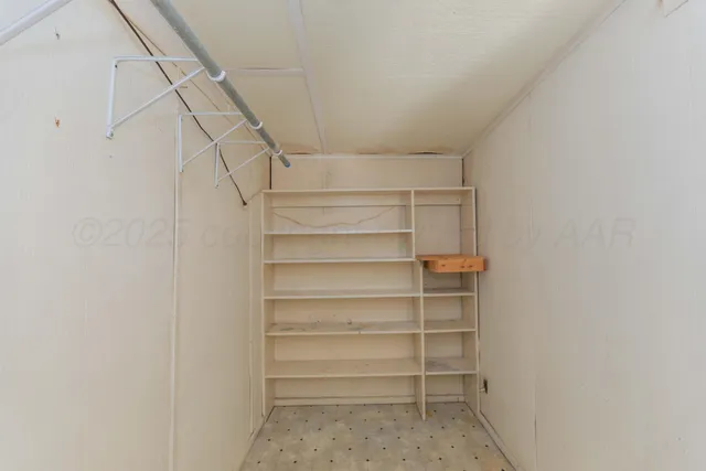 a view of backyard with wooden fence and large trees