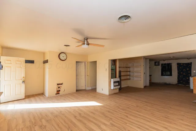 an empty room with a empty space and windows