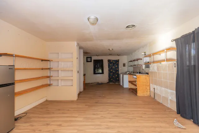 a view of empty room with cabinet and entryway