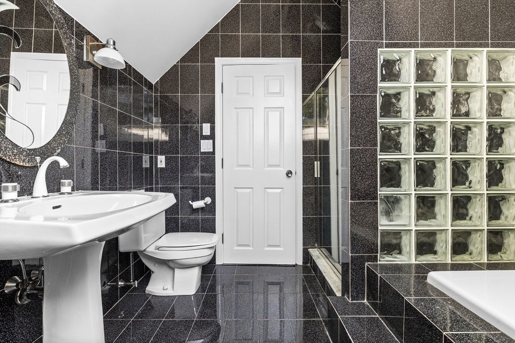 93 West R W Emerson, Unit 93R Melrose, MA 02176 - Photo 15 of 21 a bathroom with a sink a toilet and shower