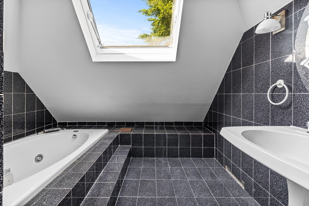 93 West R W Emerson, Unit 93R Melrose, MA 02176 - Photo 16 of 21 a bathroom with a bathtub and a shower