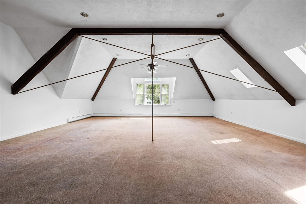 93 West R W Emerson, Unit 93R Melrose, MA 02176 - Photo 18 of 21 a view of a ceiling fan in an empty room