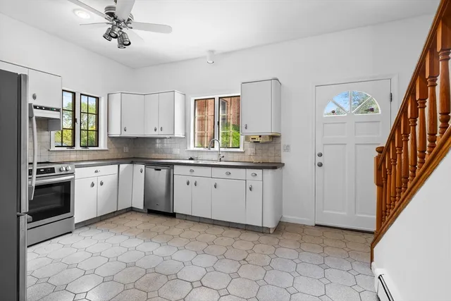 a kitchen with a sink cabinets and window