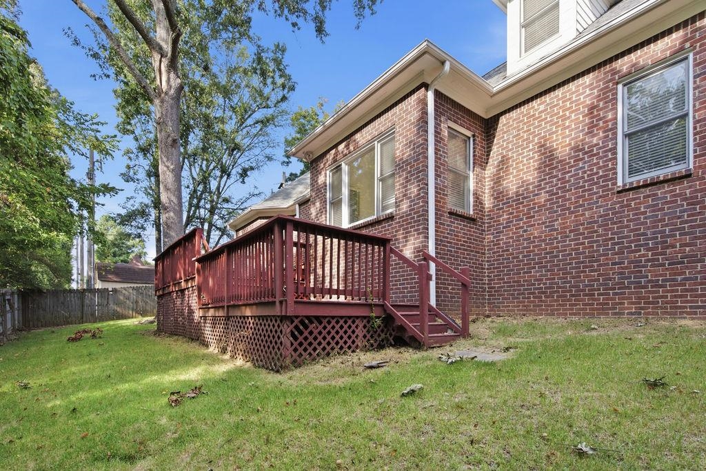 285 Great Falls Road Collierville, TN 38017 - Photo 27 of 29 Brick exterior construction with multiple windows, an elevated wood deck, and wood lattice skirting