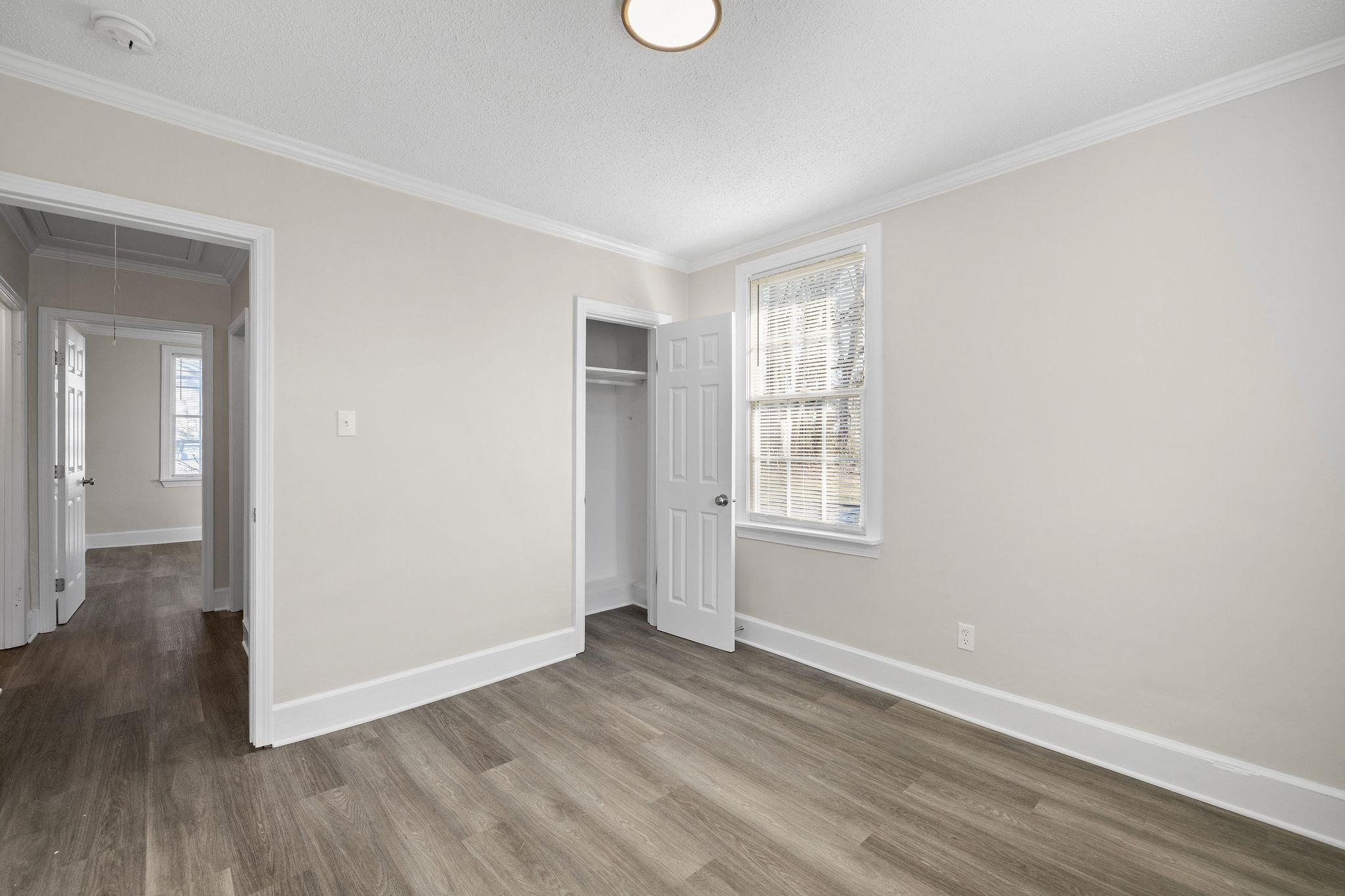 1120 Parkland Road Memphis, TN 38111 - Photo 16 of 23 Unfurnished bedroom with attic access, a closet, ornamental molding, wood finished floors, and a textured ceiling