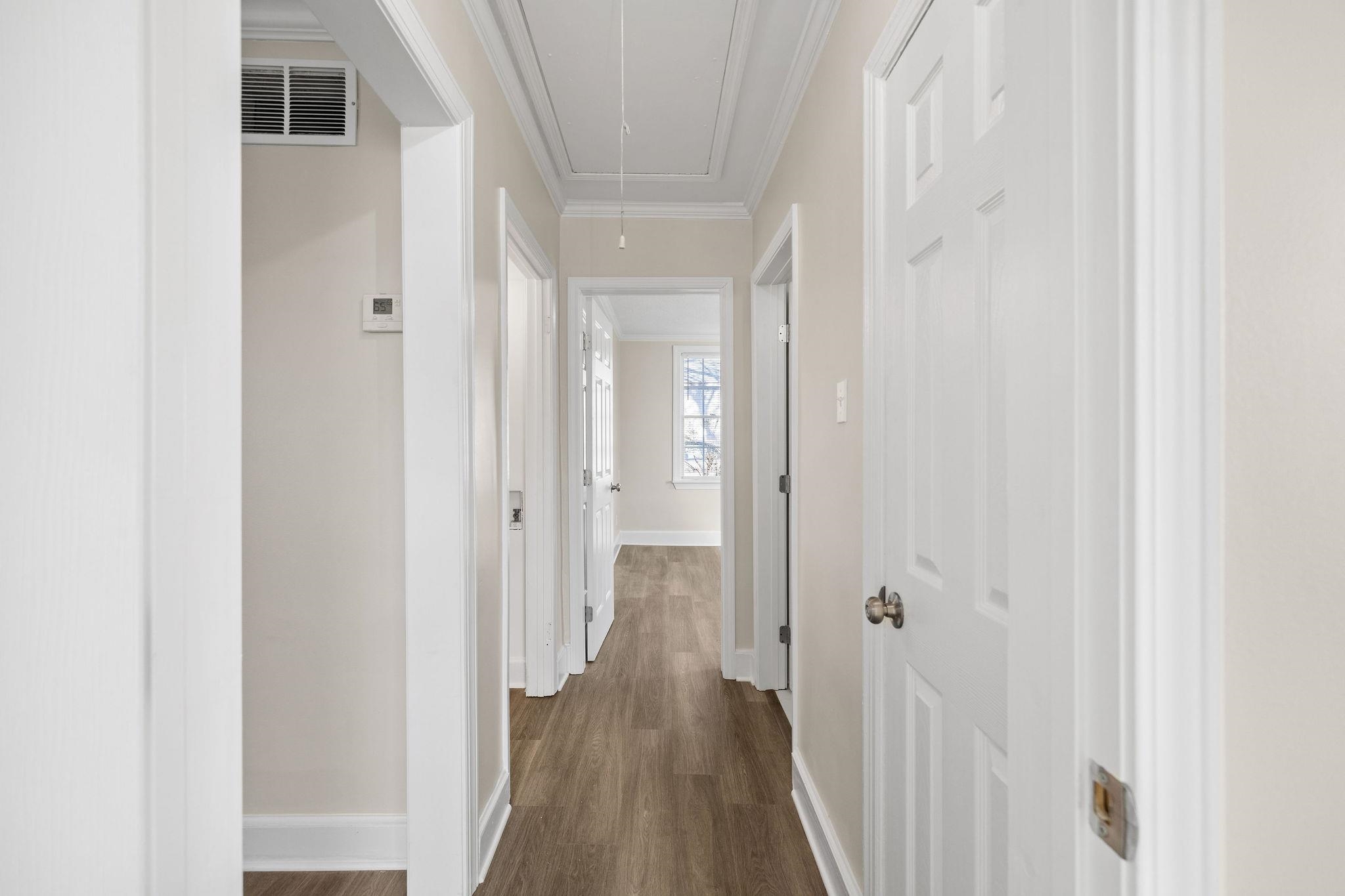 1120 Parkland Road Memphis, TN 38111 - Photo 17 of 23 Corridor with attic access, dark wood-type flooring, and ornamental molding