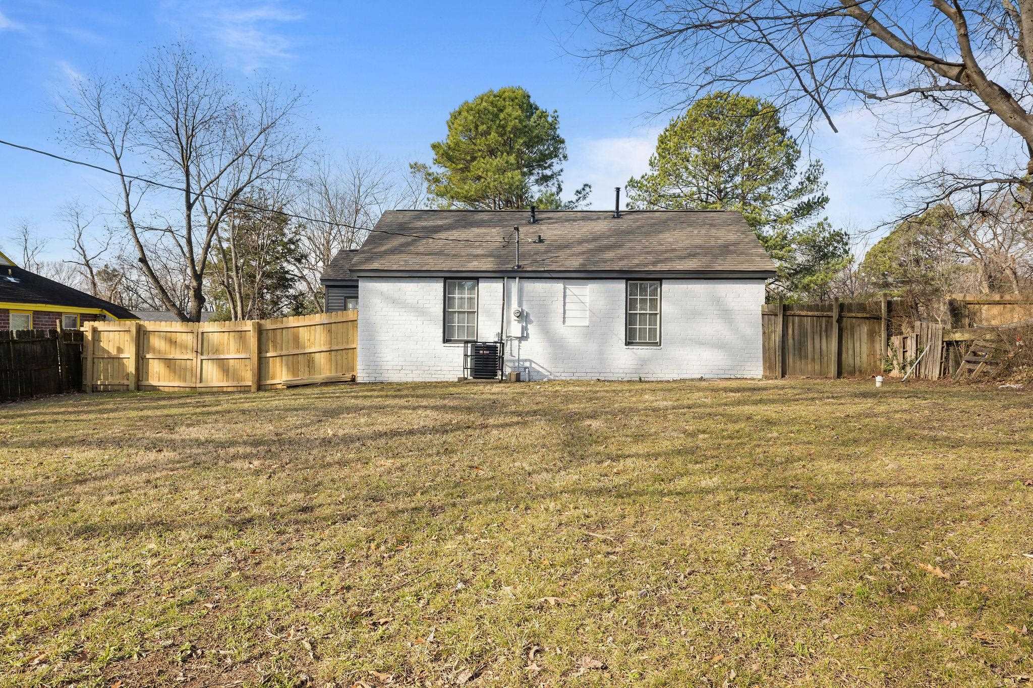 1120 Parkland Road Memphis, TN 38111 - Photo 22 of 23 Back of property with a fenced backyard and brick siding