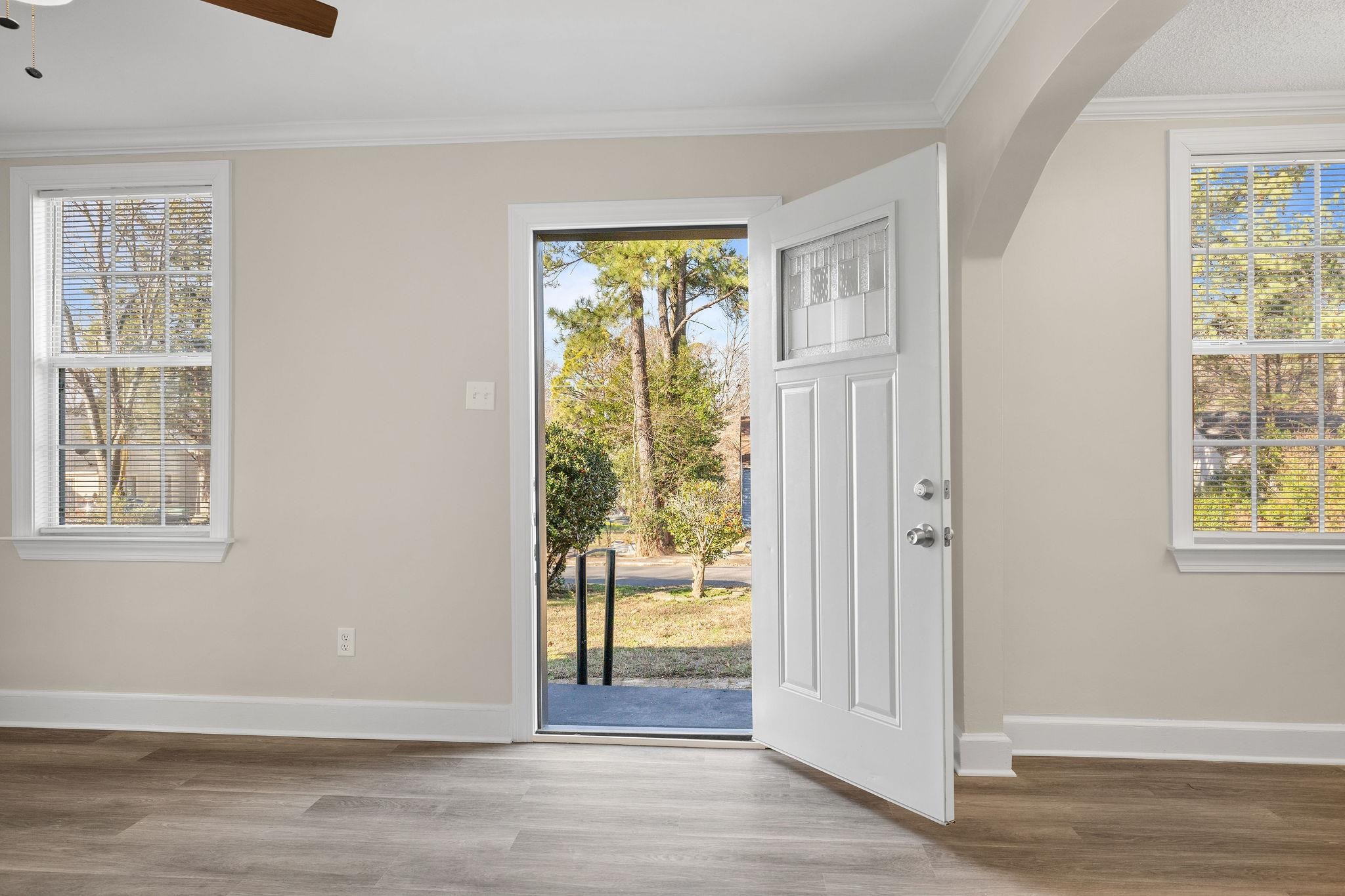 1120 Parkland Road Memphis, TN 38111 - Photo 6 of 23 Doorway featuring ornamental molding, wood finished floors, a ceiling fan, and arched walkways