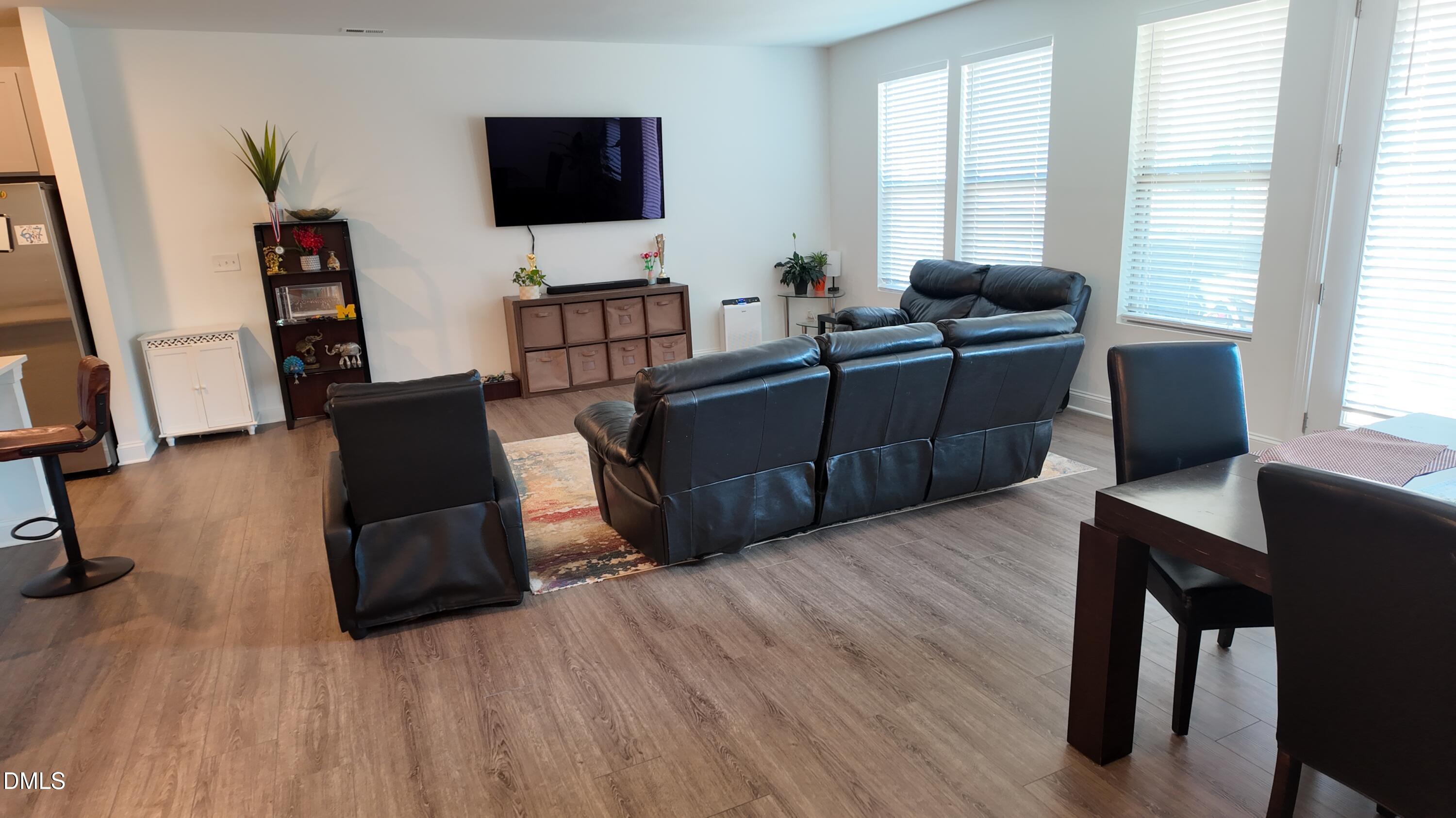 2143 Stegemann Street Apex, NC 27502 - Photo 13 of 39 a living room with furniture and a flat screen tv