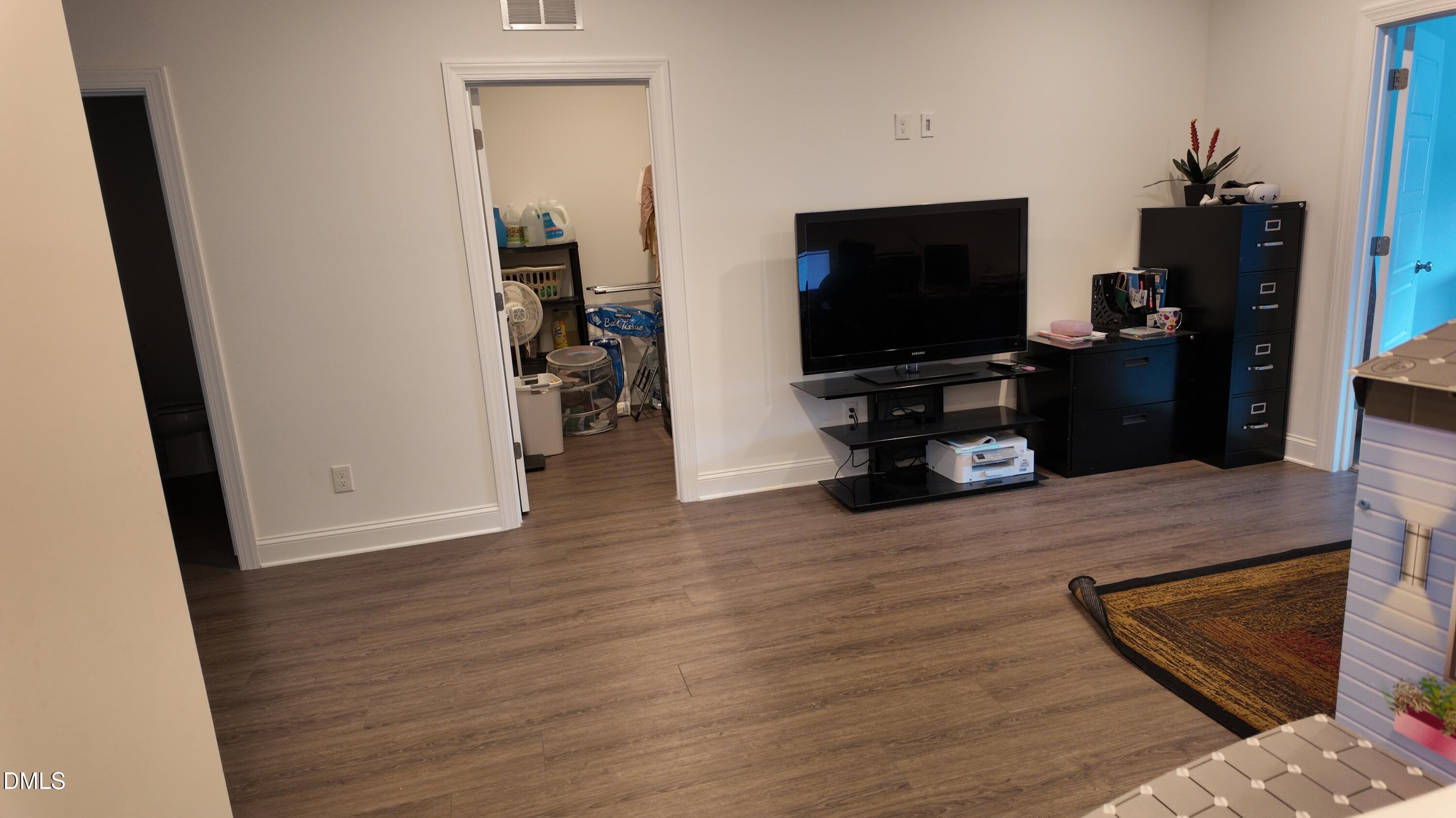 2143 Stegemann Street Apex, NC 27502 - Photo 16 of 39 a living room with furniture and a flat screen tv