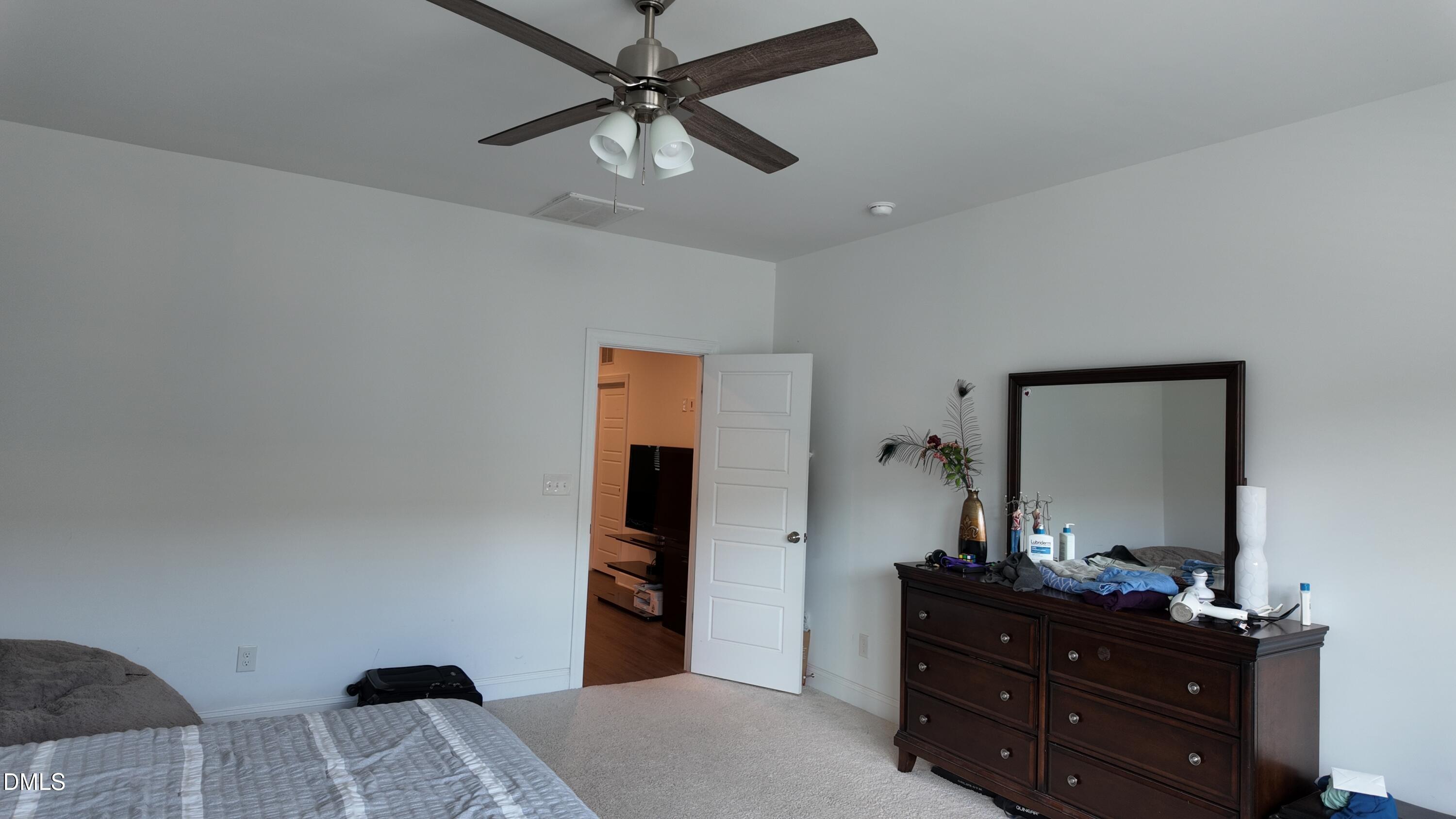 2143 Stegemann Street Apex, NC 27502 - Photo 19 of 39 a bedroom with a bed and a dresser in it