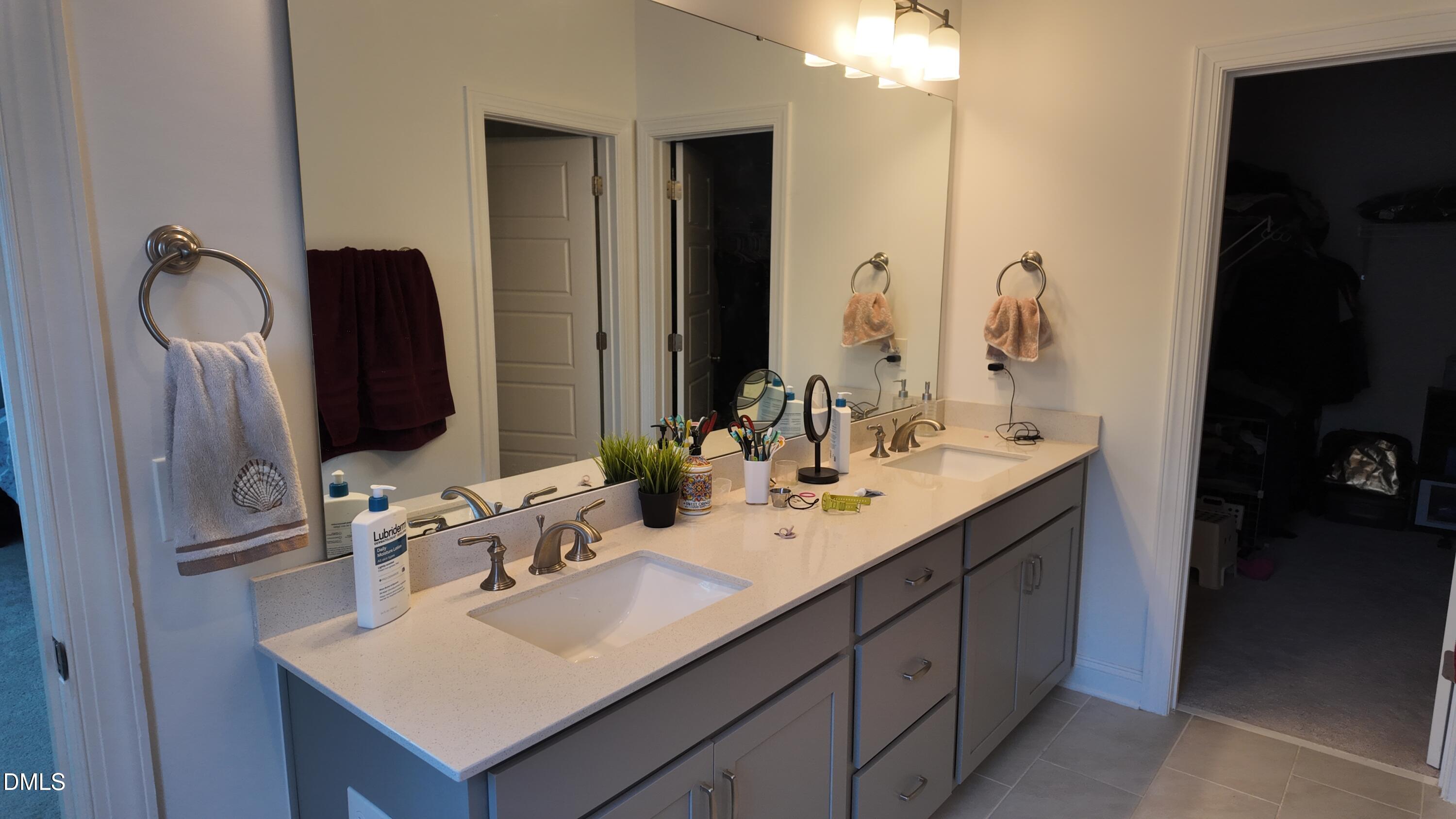 2143 Stegemann Street Apex, NC 27502 - Photo 23 of 39 a bathroom with a sink vanity and mirror