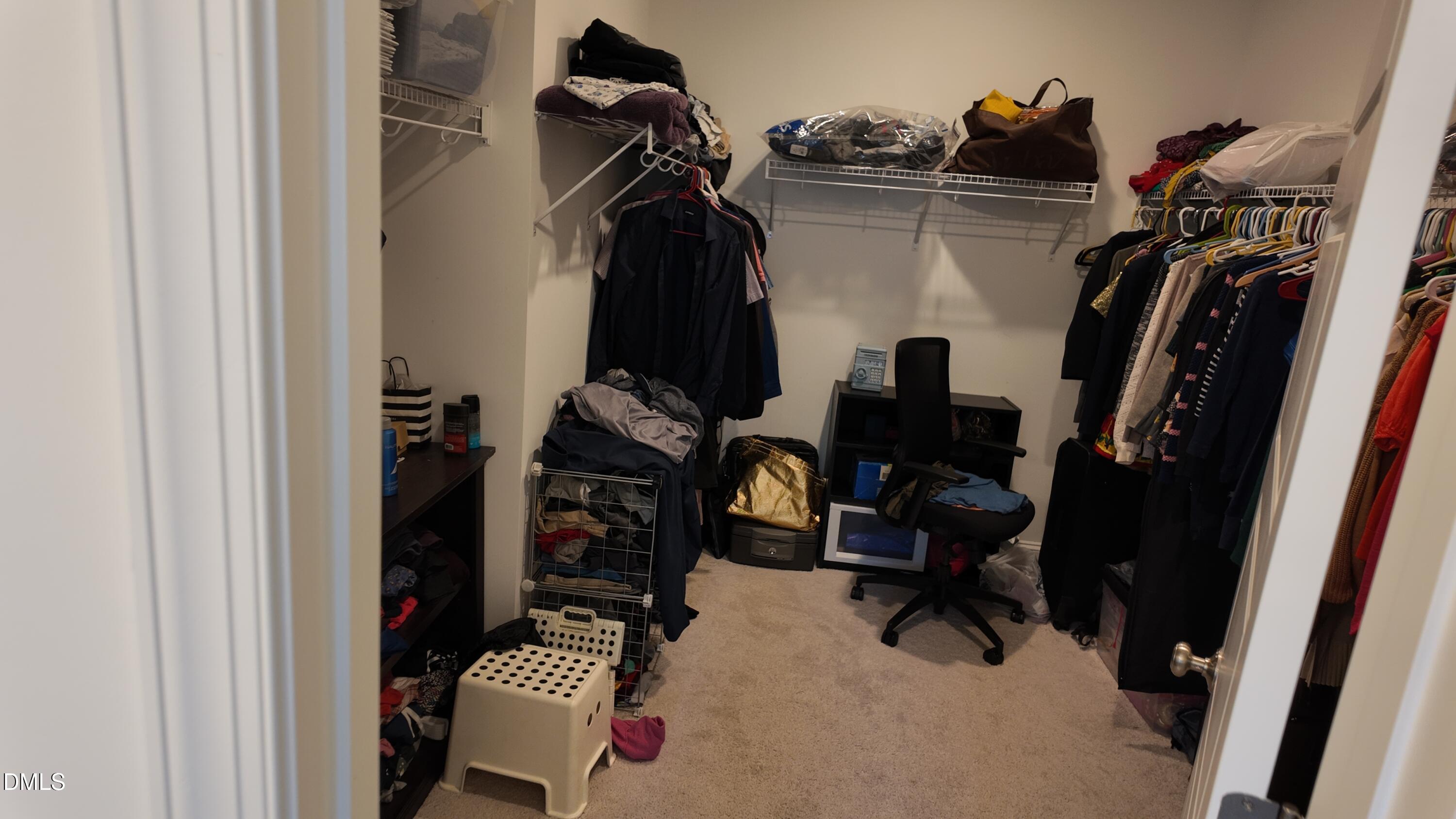 2143 Stegemann Street Apex, NC 27502 - Photo 25 of 39 a view of walk in closet with clothes and shoes