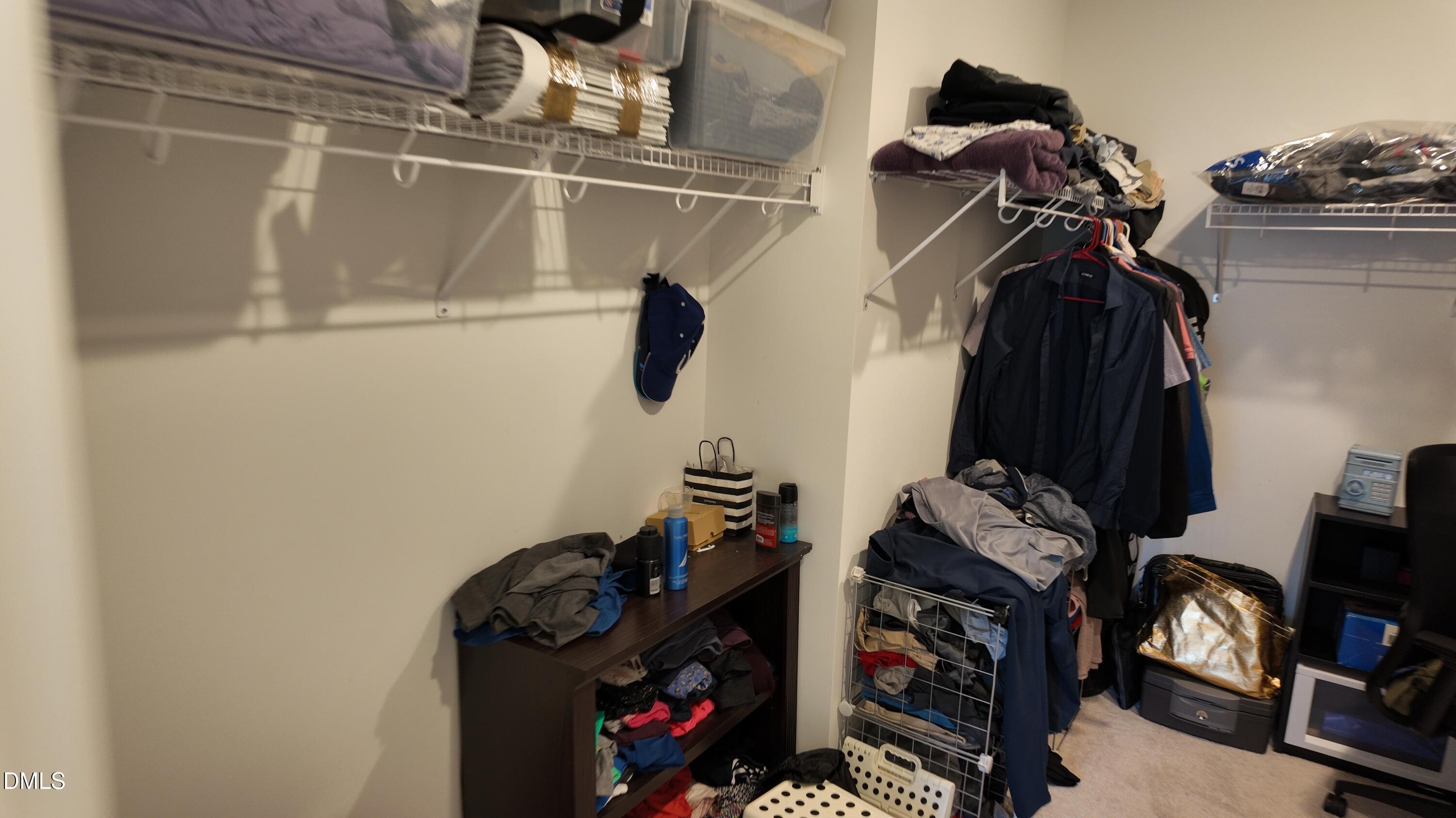 2143 Stegemann Street Apex, NC 27502 - Photo 26 of 39 a view of walk in closet with clothes and shoes