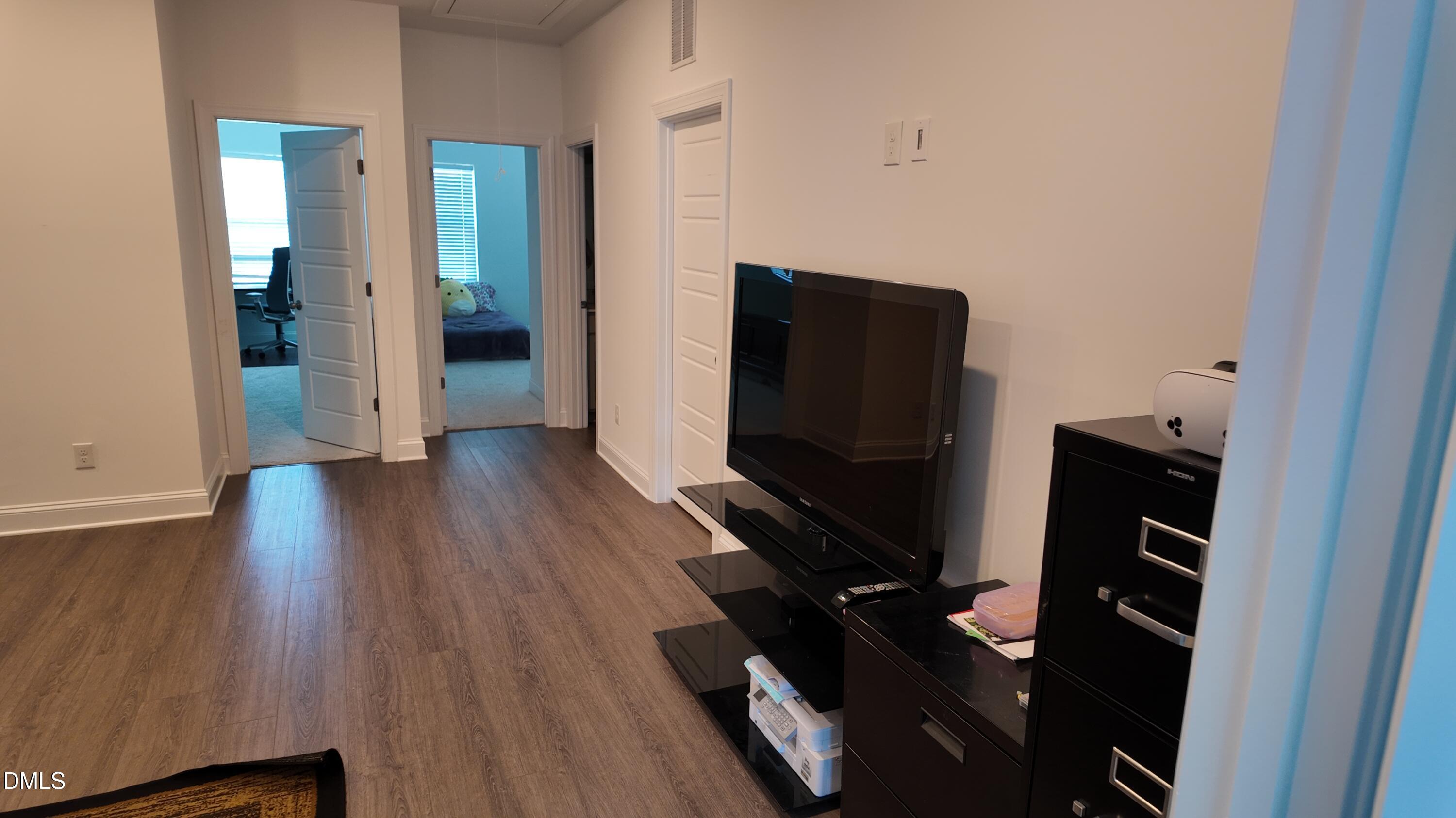 2143 Stegemann Street Apex, NC 27502 - Photo 27 of 39 wooden floor and television