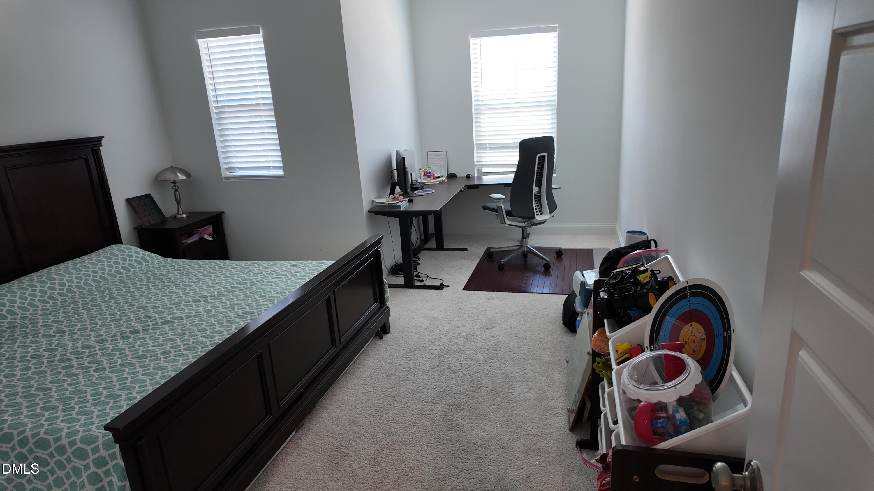 2143 Stegemann Street Apex, NC 27502 - Photo 29 of 39 a bedroom with bed and cabinets
