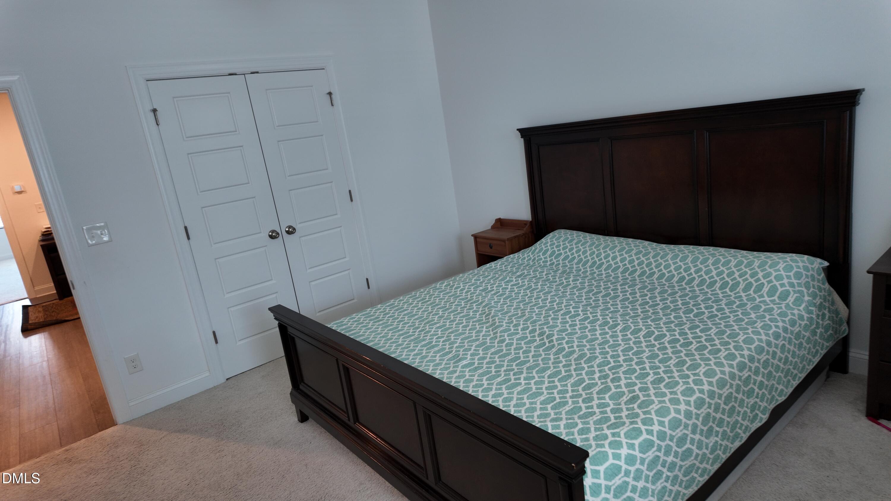 2143 Stegemann Street Apex, NC 27502 - Photo 30 of 39 a bedroom with bed and wooden floor