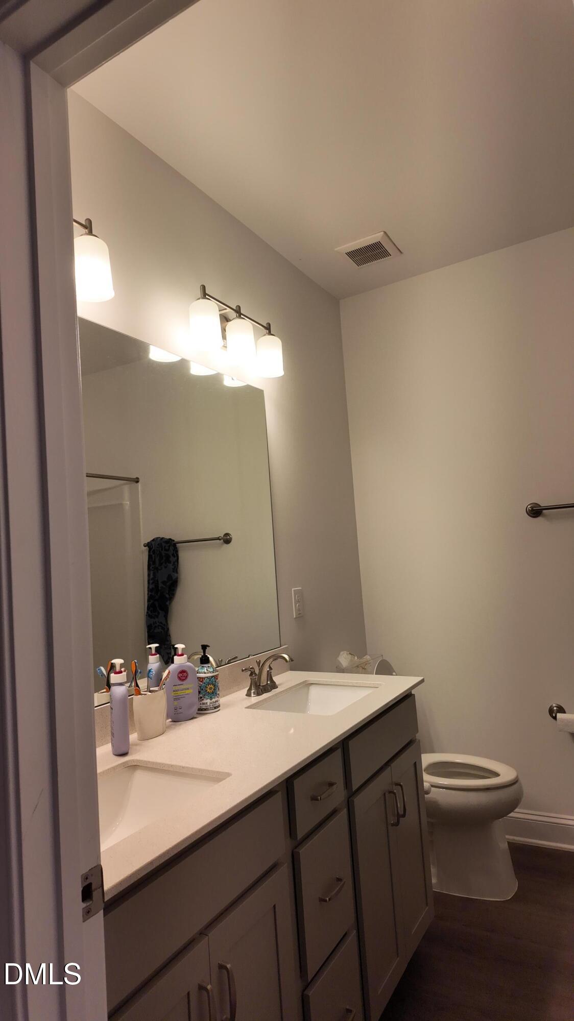 2143 Stegemann Street Apex, NC 27502 - Photo 31 of 39 a bathroom with a sink and a mirror