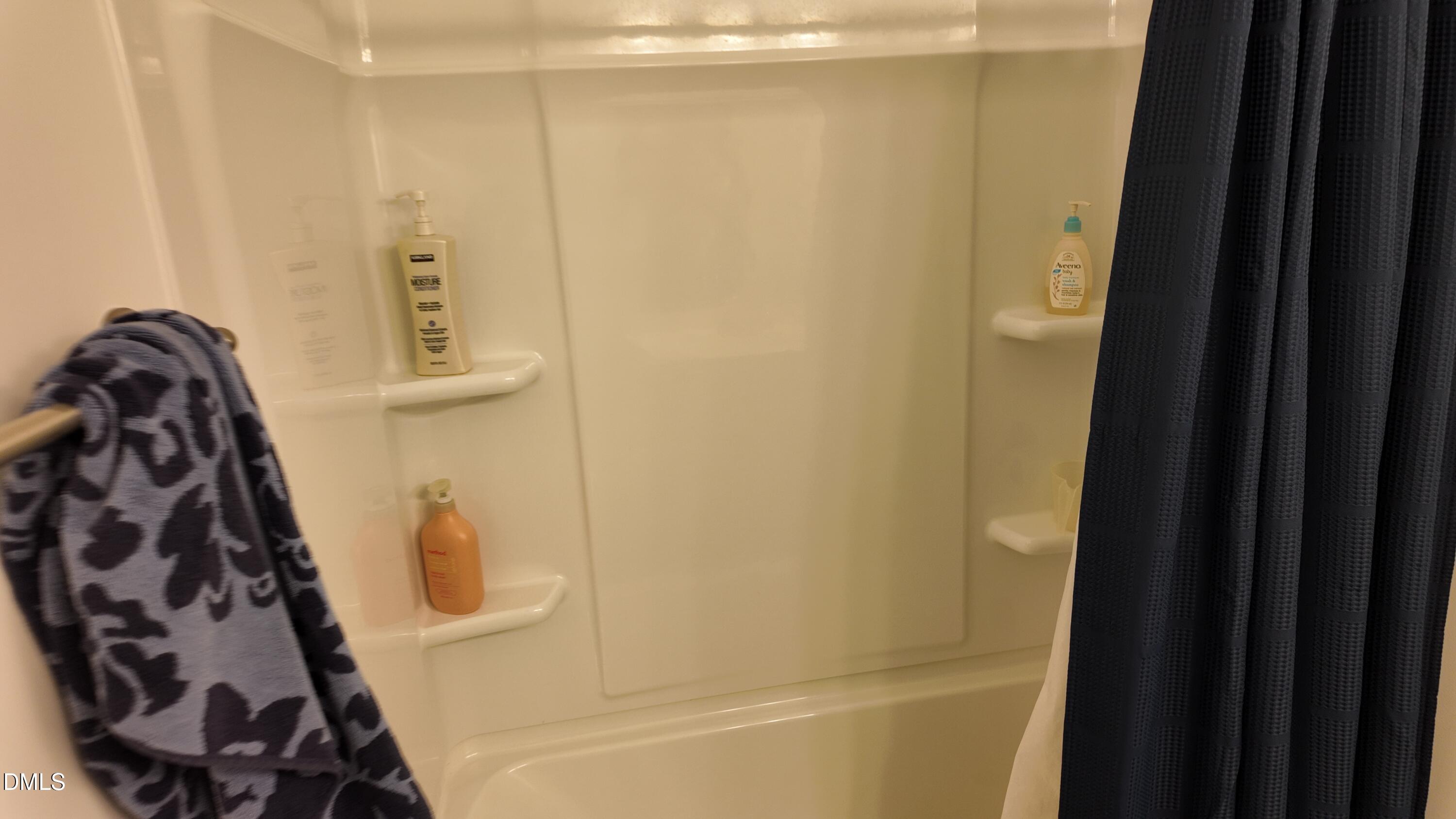 2143 Stegemann Street Apex, NC 27502 - Photo 32 of 39 a bathroom with a bathtub and shower