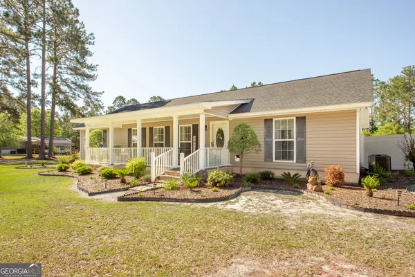 a front view of house with yard and seating space