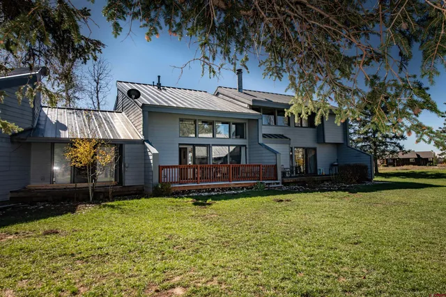 a view of a house with a yard patio and fire pit