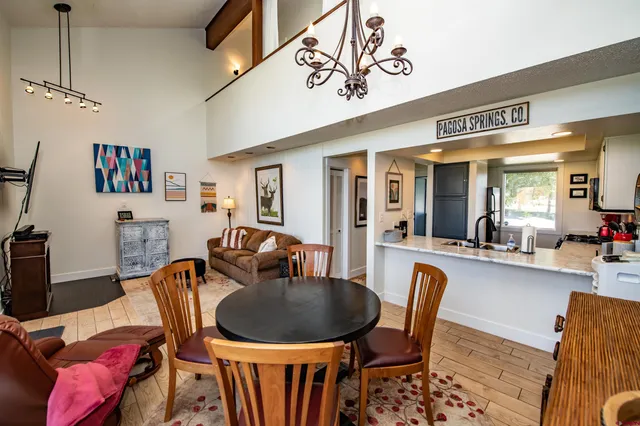 a dining room with furniture a rug and wooden floor