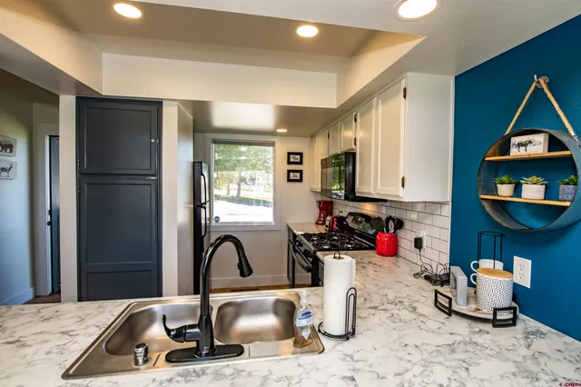 a kitchen with a refrigerator and a sink