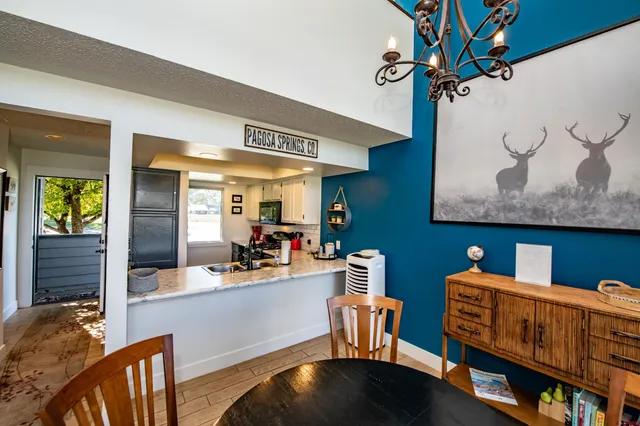 a dining room with furniture and wooden floor