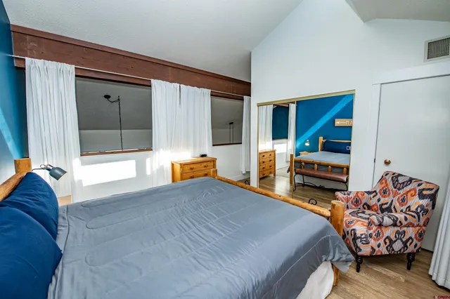 a bedroom with a bed and a couch