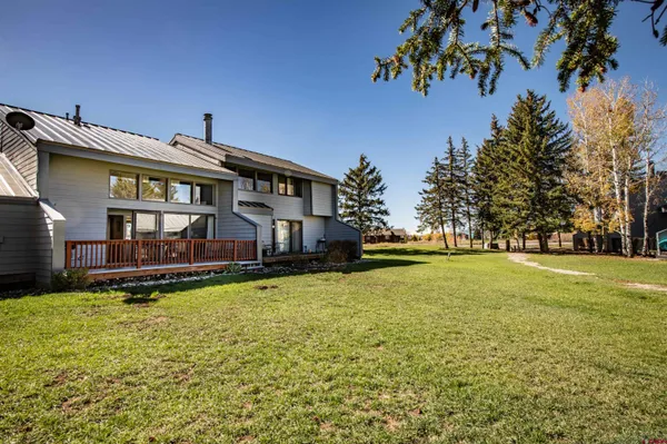 a view of a house with a yard patio and swimming pool
