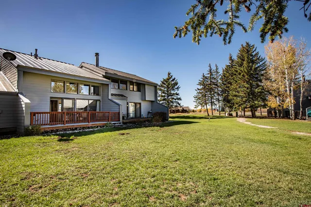 a view of a house with a yard patio and swimming pool