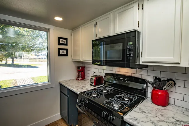 a kitchen with a stove a sink and a microwave
