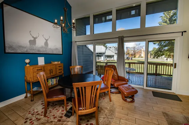 a view of a dining room with furniture a chandelier and wooden floor