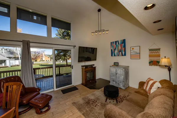 a living room with furniture fireplace and a flat screen tv