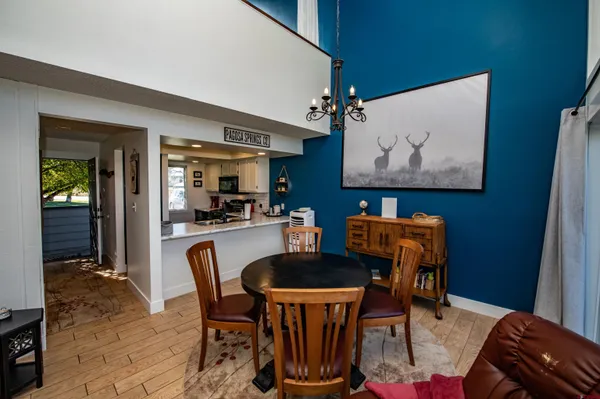 a dining room with furniture and wooden floor